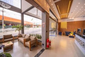 a lobby with couches and tables in a building at AIRPORT HOTEL GRU LTDa in Guarulhos