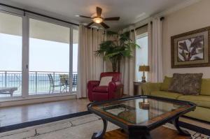 a living room with a couch and a table at Three Bedroom Corner Condo with Gulf View Balcony in Pensacola