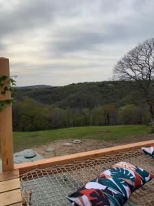 a patio with a view of a field and trees at Le dôme de Clem in Figeac