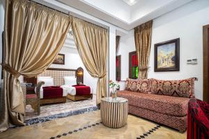 a living room with a couch and a bed at Hotel & Ryad Art Place Marrakech in Marrakesh +129 photos