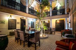 a dining room with a table and chairs at Hotel & Ryad Art Place Marrakech in Marrakesh