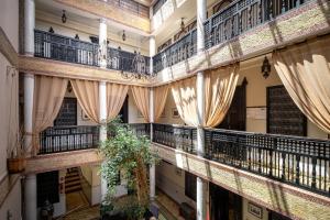an image of a building with balconies and curtains at Hotel & Ryad Art Place Marrakech in Marrakesh