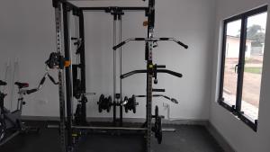 a gym with several tread machines in a room at Muzhi Wetu Lodge in Chanamo