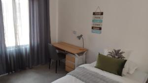 a bedroom with a desk and a bed and a desk with a computer at Muzhi Wetu Lodge in Chanamo