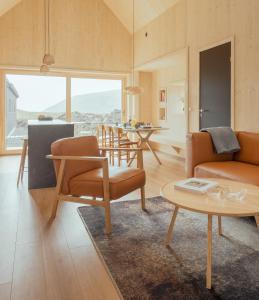 a living room with a couch and a table at The Lakehouse in Miðvágur