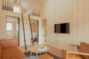 a tiny house with a staircase and a living room at The Lakehouse in Miðvágur
