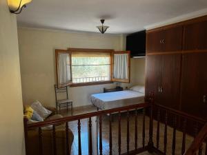 a small bedroom with a bed and a window at Les Fonts in Cabacés