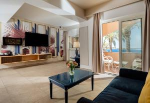 a living room with a couch and a table at Altafiumara Resort & Spa in Villa San Giovanni