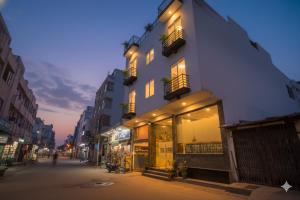 a building on the side of a street at night at Hotel The Tark Near Delhi Airport in Champawat
