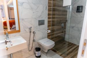 a bathroom with a toilet and a shower and a sink at The MU City Hotel Trabzon in Trabzon +56 photos