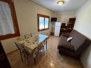 a living room with a table and a couch at Les Fonts in Cabacés