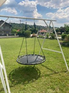 a swing in the middle of a yard at Nevade home in Gornji Milanovac