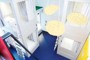 an overhead view of a room with white and yellow pendants at Maverick Budapest Soho in Budapest