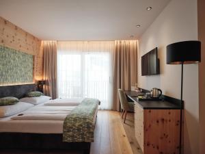 a hotel room with a bed and a desk at Cityhotel Goldener Adler B&B in Chiusa +79 photos