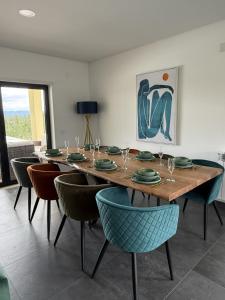 a dining room with a wooden table and chairs at Casa na Colina - Private Pool & Jacuzzi in Santiago da Guarda