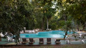 a swimming pool with chairs and a table and chairs at Complejo Paranay in Puerto Paranay