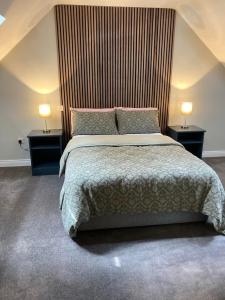 a bedroom with a large bed with two night stands at Cope House Rooms in Killybegs +12 photos