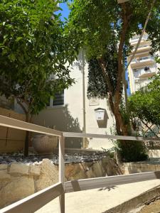a white fence in front of a building at JOHNMAR apartment in Athens