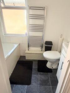a bathroom with a toilet and a tub and a sink at Premium Bedroom Escape in Hull +4 photos