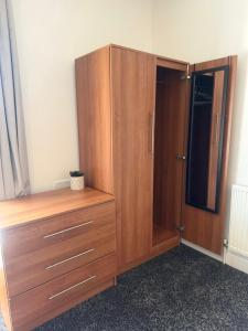 a large wooden cabinet in a room at Premium Bedroom Escape in Hull