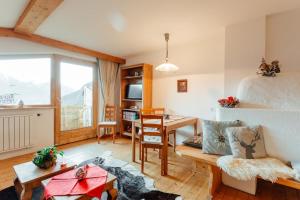 a room with a bed and a table and a dining room at Appartement RUDI by MoniCare in Reith bei Seefeld