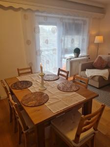 a wooden table with a candle on it in a living room at Appartement SISI by MoniCare in Seefeld in Tirol