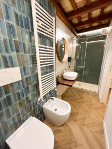 a bathroom with a toilet and a sink and a shower at Residenza Veneto 80 in Vasto +42 photos