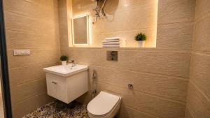a bathroom with a toilet and a sink and a mirror at HOTEL GREEN VEGAS in New Delhi +33 photos