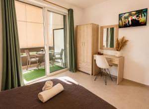 a bedroom with a bed and a table with chairs at Maquestas Modern Apartments in Archangelos