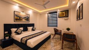 a bedroom with a bed and a table with a chair at HOTEL GREEN VEGAS in New Delhi