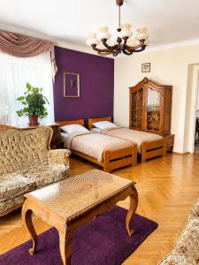 a living room with two beds and a couch at Astronomical Clock Apartment in Prague