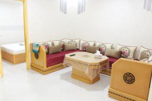 a living room with a couch and a table at Apart al hoceima in Al Hoceïma +5 photos