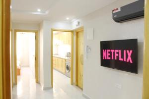 a living room with a television on a wall at Apart al hoceima in Al Hoceïma
