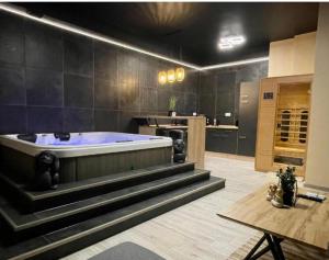 a large bathroom with a large tub in a kitchen at Ancram SPA Miskolc in Miskolc