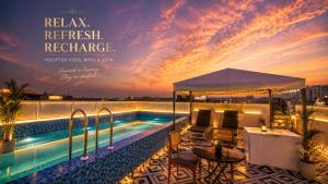 a resort with a swimming pool at sunset at HOTEL GREEN VEGAS in New Delhi