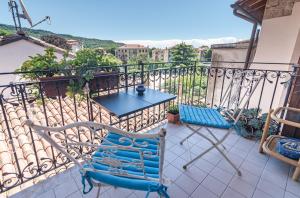 a balcony with a blue chair and a table at Torre Cà Emo, Il Bilocale "Leone di San Marco" in Vittorio Veneto