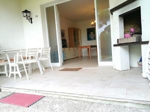 a living room with a table and chairs and a patio at Villa Duna Verde in Duna Verde