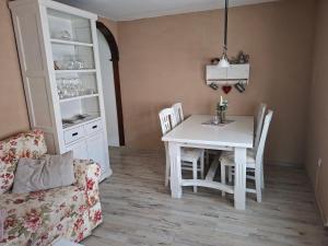 a dining room with a white table and chairs at Fewo Froschkönig in Schieder-Schwalenberg +21 photos