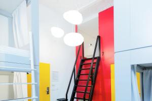 a staircase in a room with colorful walls at Maverick Budapest Soho in Budapest