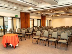 a room with a bunch of chairs and a table at Park Royal Beach Huatulco in Tangolunda +61 photos
