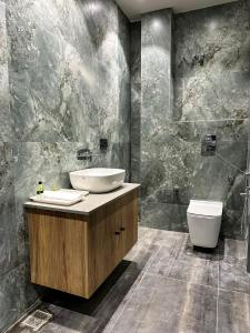 a bathroom with a sink and a toilet at hotel fior in Pānīpat