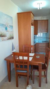 a kitchen with a wooden dining room table and chairs at Sunrise Hill Guest House in Los Gallardos