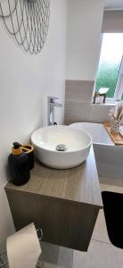 a bathroom with a white sink on a counter at Stoney Lane Cottage in Wakefield +40 photos