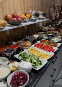 a buffet with many plates of food on a table at Aziza Hotel White Tashkent in Yakkasaray