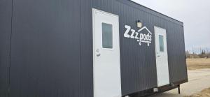 a black building with two white doors on it at A magical get away experience in Matlock
