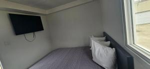 a bedroom with a bed with a tv on the wall at A magical get away experience in Matlock