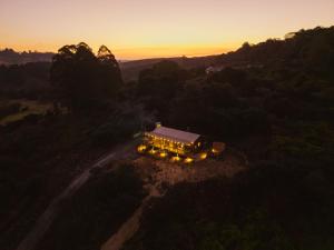 an aerial view of a house with lights on a road at AfriCamps at Gowan Valley in Balgowan