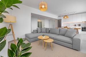 a living room with a gray couch and a table at Aegean View Estate - Villa in Faliraki