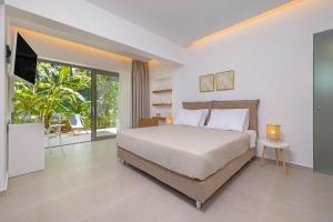 a bedroom with a bed and a large window at Aegean View Estate - Villa in Faliraki
