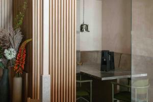 a room with a desk and a table with a computer at Buckle Street Studios by Locke, Aldgate in London +9 photos